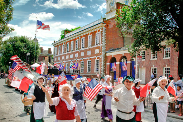 A Parade passes in front of Independence Hall
